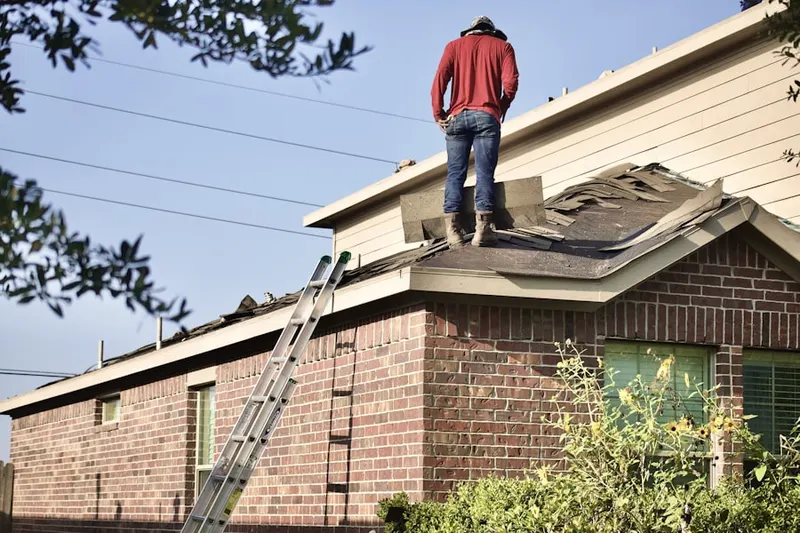 Professional roofer working on a residential roof in Poinsettia Heights